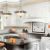 Modern kitchen interior with clean surfaces, bright lighting, and stylish fixtures, emphasizing air quality and cleanliness during home renovations.