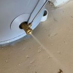 Water heater drainage valve releasing water, illustrating the maintenance process for efficient hot water systems.