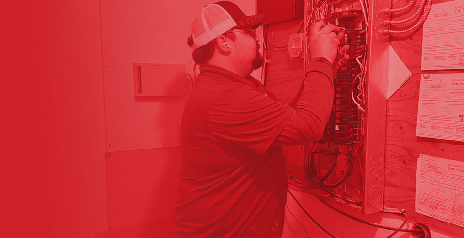 Technician working on electrical panel, ensuring safe and efficient electrical service for home systems.