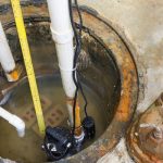 Sump pump installation showing primary and backup pumps in a sump pit, emphasizing water management for flood prevention.